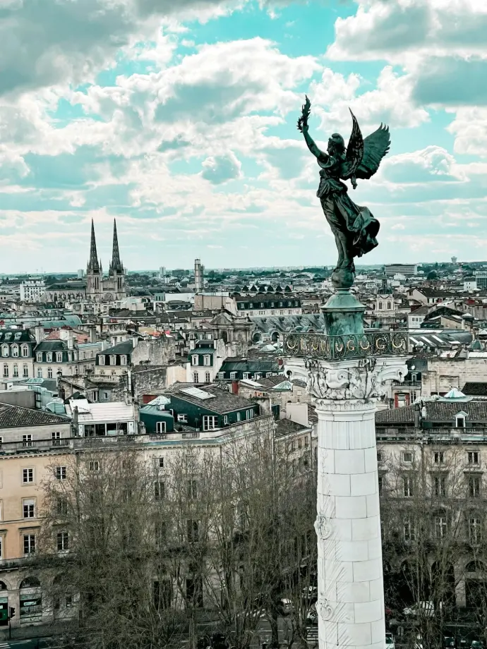 a statue of an angel on top of a building